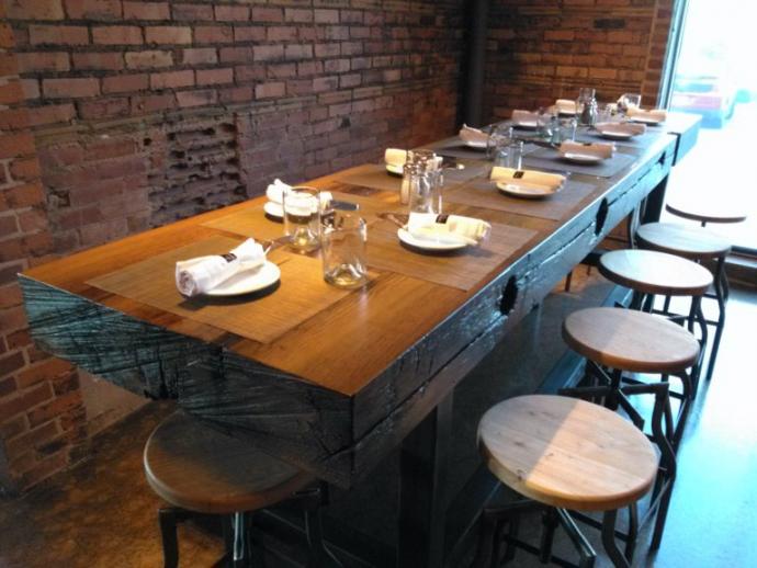 A Rochester, NY restaurant made space for two heavy 6″x32″x10′ slabs crafted from the Welland Timbers by NEWwoodworks. The resulting community-style tables have fresh sawn tops showing the Douglas fir’s mineral staining and tight grain with original as-found timber edges.